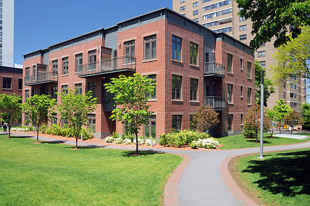 Brick multifamily apartment building with landscaped grounds