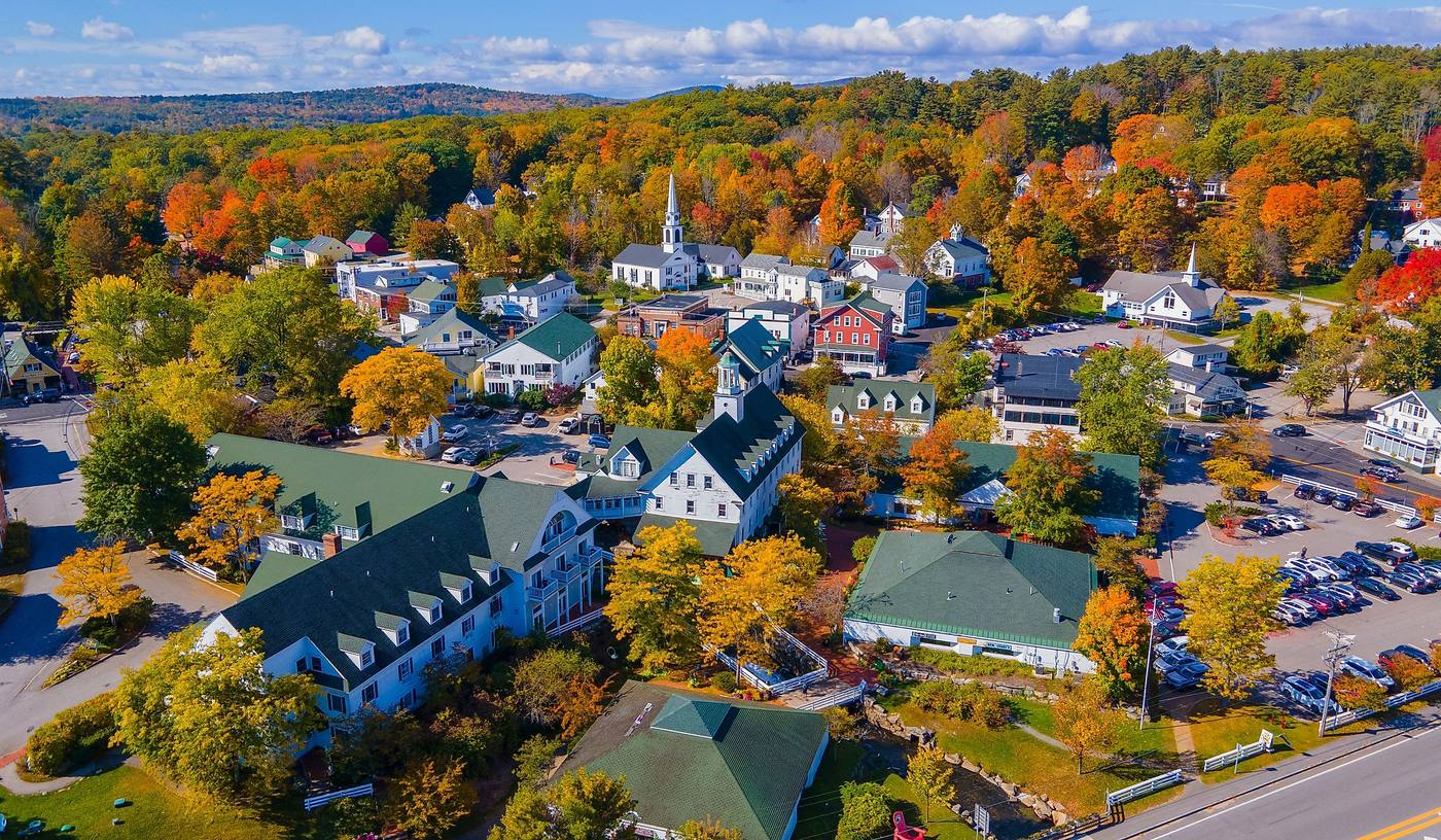 A New England town surrounded by autumn foliage