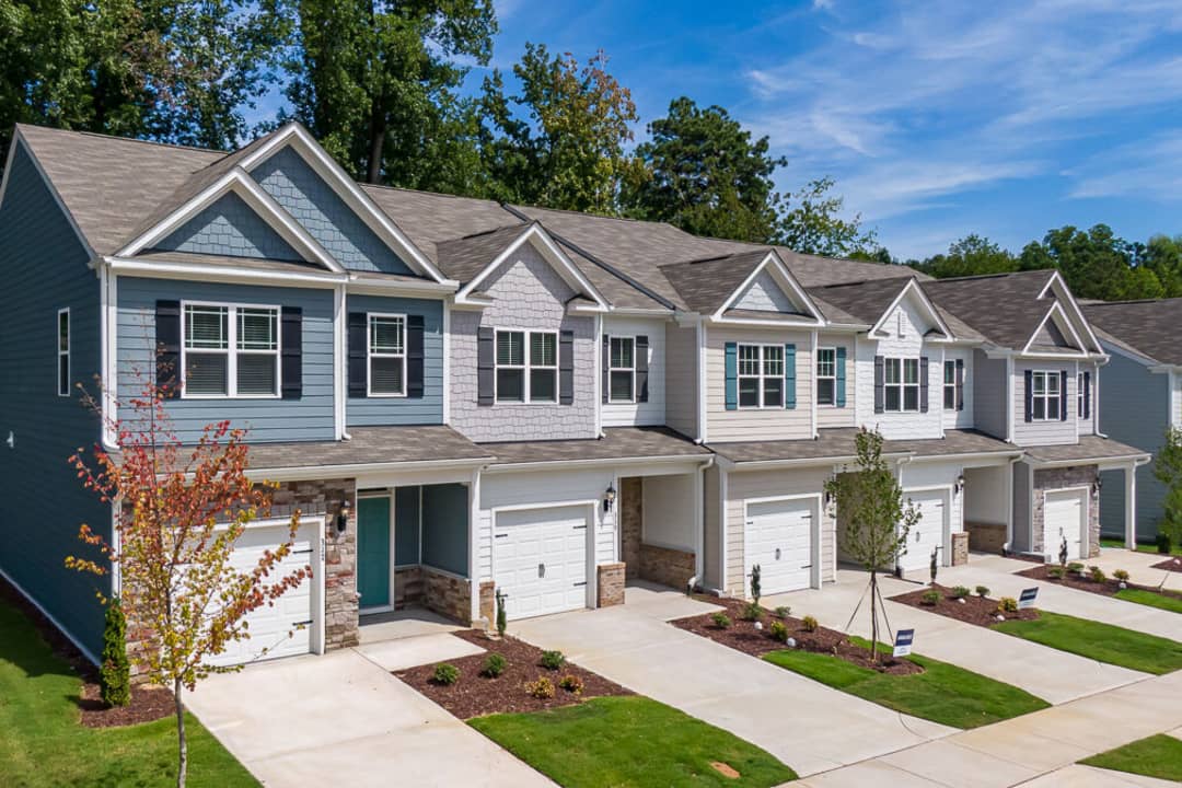 A neighborhood of townhomes with landscaped front yards